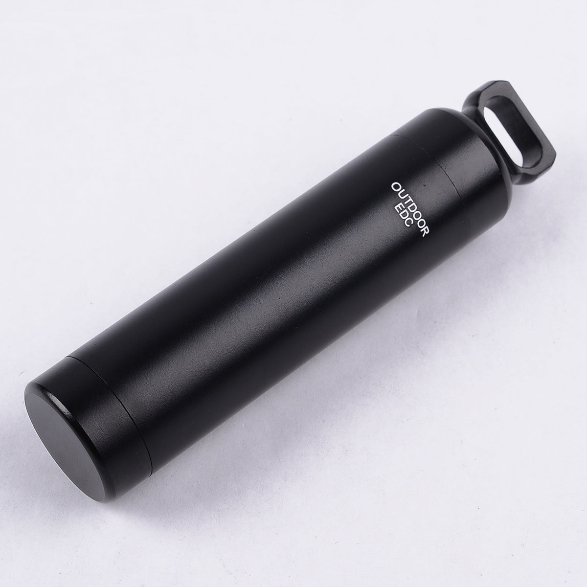 Aluminium alloy pill box with an airtight screw top.