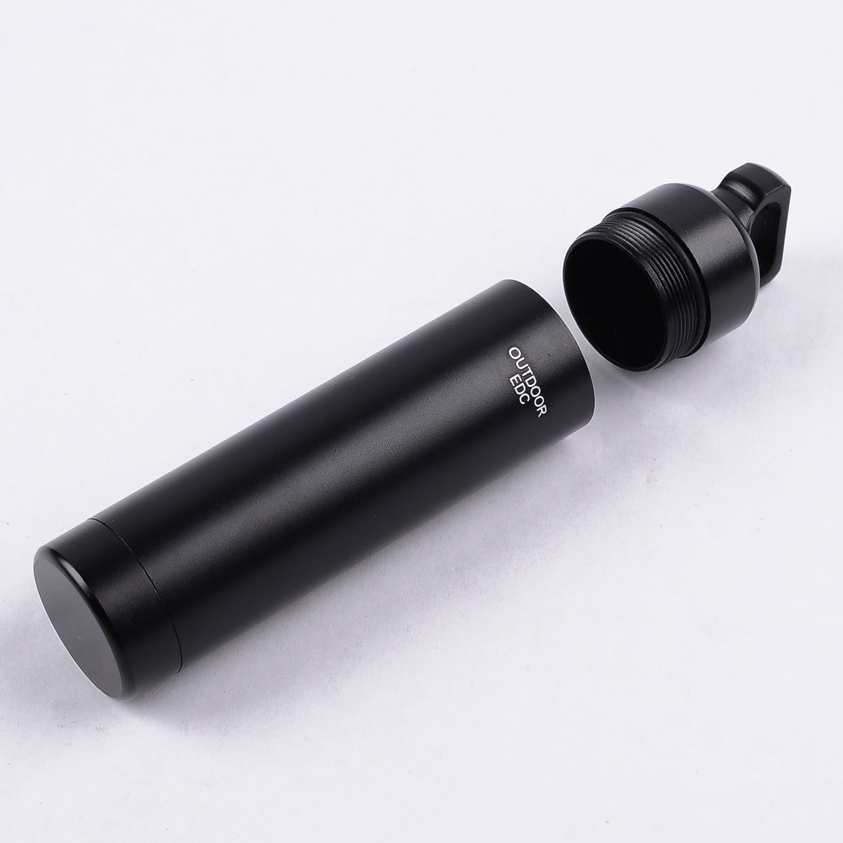 Aluminium alloy pill box with an airtight screw top, alternative view.